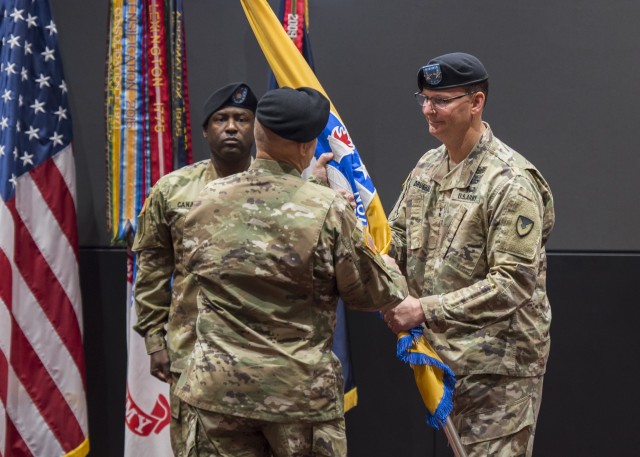 Maj. Gen. Jeffrey Drushal, U.S. Army Security Assistance Command's commanding general, the outgoing commander, passes the colors to Lt. Gen. Edward Daly, deputy commanding general of Army Materiel Command, while Command Sergeant Major Gene Canada, center, observes. Dr. Myra  Gray, U.S. Army Security Assistance Command's Senior Executive Service officer and deputy to the commanding general, will assume Executive Director duties upon the conclusion of the relinquishment of command ceremony, 2 June 2020, at Redstone Arsenal. The event was hosted to a socially distanced audience with widespread online presence live-streamed through social media. (Photo by Richard Bumgardner, USASAC Public Affairs)