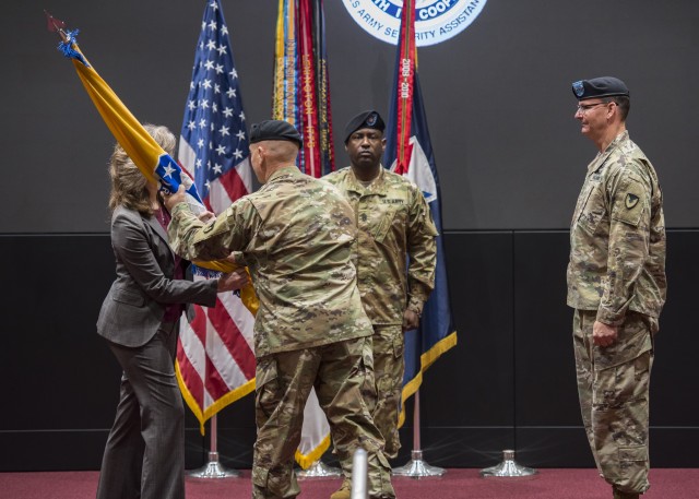 Lt. Gen. Edward Daly, deputy commanding general of Army Materiel Command, passes the colors to Dr. Myra  Gray, U.S. Army Security Assistance Command's Senior Executive Service officer and deputy to the commanding general, who will assume Executive Director duties upon the conclusion of the relinquishment of command ceremony, 2 June 2020, at Redstone Arsenal. Maj. Gen. Jeffrey Drushal, right, the outgoing commanding general, and Command Sergeant Major Gene Canada, center, observe the passing of the colors, a traditional act marking change of authority. The event was hosted to a socially distanced audience with widespread online presence live-streamed through social media. (Photo by Richard Bumgardner, USASAC Public Affairs)