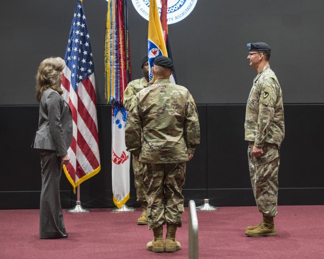 Command Sergeant Major Gene Canada, behind unit flag in center, prepares to pass the colors to Maj. Gen. Jeffrey Drushal, right, U.S. Army Security Assistance Command's commanding general, who is the outgoing commander, at a relinquishment of command ceremony, 2 June 2020, at Redstone Arsenal. Lt. Gen. Edward Daly, center with back to camera, the deputy commanding general of Army Materiel Command, hosted the event where responsibility of the unit will be passed to Dr. Myra  Gray, left, USASAC's Senior Executive Service officer and deputy to the commanding general, who will assume Executive Director duties upon the conclusion of the relinquishment of command ceremony. The event was hosted to a socially distanced audience with widespread online presence live-streamed through social media. (Photo by Richard Bumgardner, USASAC Public Affairs)