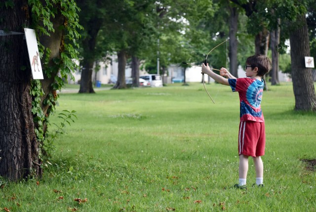 Teddy Leatherbee, 7, shoots his toy bow and arrow at a dinosaur target while participating in the Jurassic SHA Nerf Dinosaur Hunt at the Sagamihara Family Housing Area, Japan, June 2.