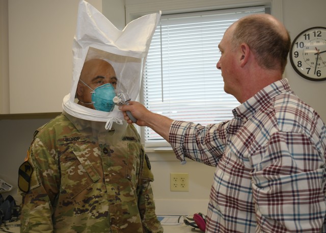 FORT DRUM, N.Y. – Bart Bushen (right), a supervisory industrial hygienist with the Fort Drum Medical Activity, and a native of Apalachin, N.Y., conducts a fit test of an N-95 respirator mask on Sgt. 1st Class Clarence Bishop (left), the Fort Drum MEDDAC preventive medicine senior noncommissioned officer, on Fort Drum May 29. Since the start of the COVID-19 pandemic, the MEDDAC industrial hygiene team has conducted respirator fit tests on more than 400 Fort Drum employees, ensuring wearers have the correct mask and understand the proper procedures for wear. (U.S. Army photo by Warren W. Wright Jr., Fort Drum Medical Activity Public Affairs)