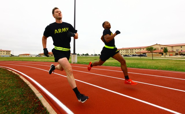 Sgt. Thomas Massengill, A Battery, 1st Battalion, 30th Field Artillery, and a teammate run 800 meters during the Cornerstone Fitness Challenge May 21, 2020, at 1st Battalion, 78th Field Artillery's Teamwork Field.