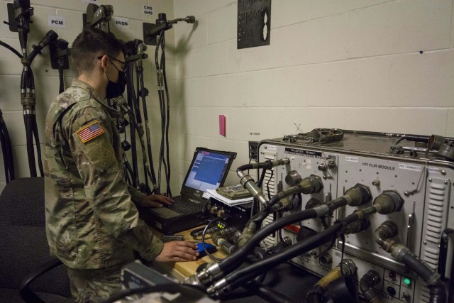 A Soldier from the 101st Brigade Support Battalion, 1st Armored Brigade Combat Team, 1st Infantry Division armament shop maintains equipment at Fort Riley, Kans. while wearing personal protective equipment. Liberty Battalion Soldiers have implemented procedures to protect the force and prevent the spread of the pandemic while maintaining mission essential readiness.