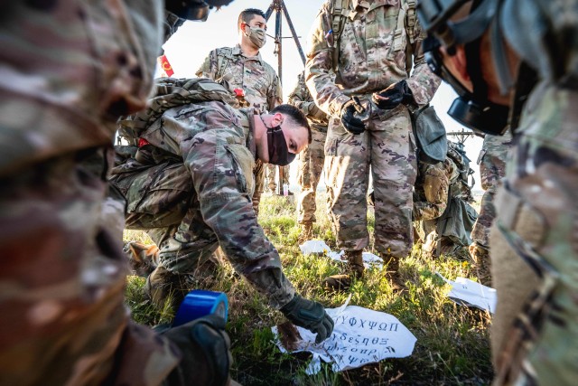 A Cerberus Battery Soldier attempts to decode a message during a physical training session high atop Medicine Bluffs, May 29, 2020, at Fort Sill, Oklahoma. The message told Soldiers which keys to use to unlock a box.