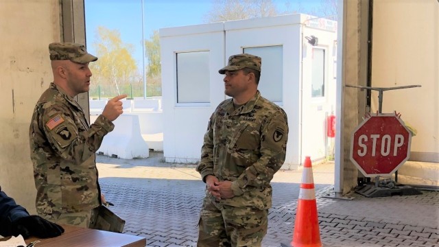 U.S. Army Garrison Rheinland-Pfalz Commander Col. Jason T. Edwards and Lt. Col. Jonathan Ackiss, Commander of Defense Logistics Agency Distribution Europe, discuss entry control and screening operations at one of the Germersheim Army Depot gates April 1. 