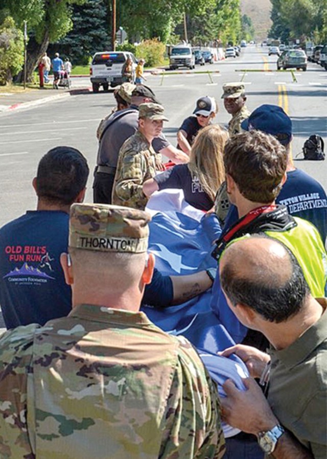JACKSON HOLE, Wyo. — Better Opportunities for Single Soldiers (BOSS) volunteers assisted with a large city event in Jackson Hole, Wyoming, Sept. 11, 2019. Soldiers helped first responders fold the American Flag near the end of the event. (Courtesy photo)