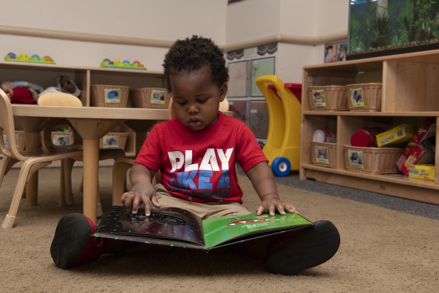 A child reads a book May 1, 2020, inside Child Development Center 3 at Travis Air Force Base, Calif. The center is one of three childcare centers at Travis AFB that provide care for children from six weeks to 5-years-old. 