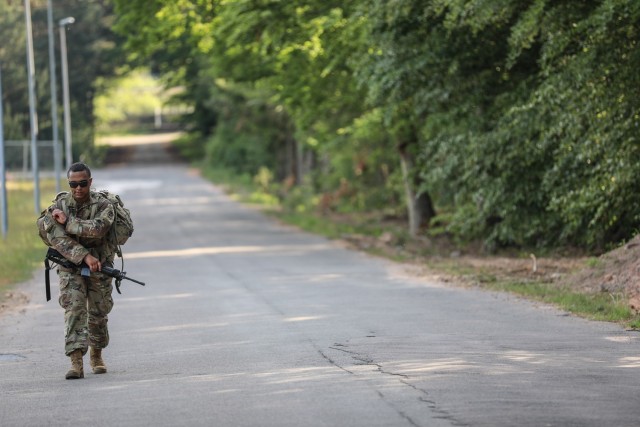 RHINE ORDNANCE BARRACKS, Germany - Staff Sgt. Ian Ledesma, a patriot section chief assigned to Alpha Battery, 5th Battalion, 7th Air Defense Artillery Regiment finishes up the unknown distance foot march on Rhine Ordnance Barracks June 3. Ledesma...