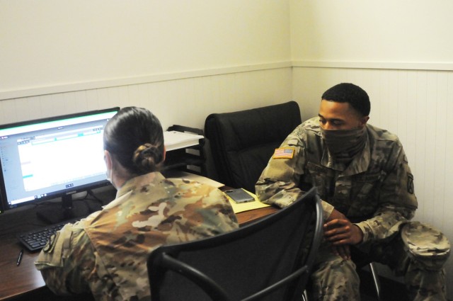 Spc. Paige Barnnett, 317th Brigade Engineer Battalion, 3rd Brigade Combat Team, 10th Mountain Division, a tax specialist at the Fort Polk Installation Tax Center, helps Pvt. Brandon Grigg, 2nd Battalion, 4th Infantry Regiment, 3rd Brigade Combat Team, 10th Mountain Division, get his taxes done June 1.