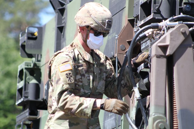 BAUMHOLDER, Germany - Spc. David Buemi, a Patriot launching station enhanced operator assigned to Charlie Battery, 5th Battalion, 4th Air Defense Artillery Regiment checks and secures cables on the Patriot Launching Station outside of Baumholder, Germany May 18.