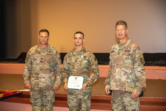 From left to right: 25th Infantry Division Command Sergeant Major, Command Sgt. Maj. William Pouliot, Sgt. Patiellos Faria, an Infantryman with 1st Battalion, 27th Infantry Regiment, 2nd Brigade Combat Team, 25th Infantry Division, and 25ID...
