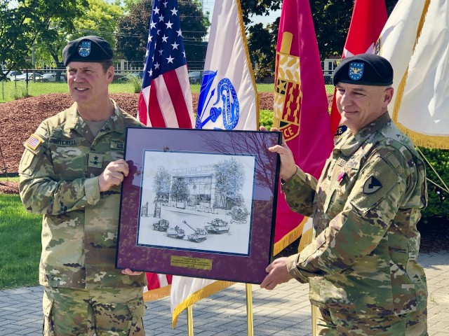 Maj. Gen. Dan Mitchell (left), commanding general Tank-automotive and Armaments Command, presents Col. Jeffrey Witt, TACOM Chief of Staff, with a small gift during his the colonel’s retirement ceremony at the Detroit Arsenal June 5.