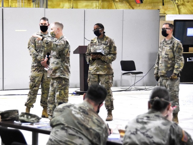 Brig. Gen. Patrick D. Frank, commander, JRTC and Fort Polk, speaks to members of 4th SFAB during a reception, staging, onward movement, and integration rehearsal brief on May 28 while adhering to COVID-19 mitigation measures. Pictured, from left...