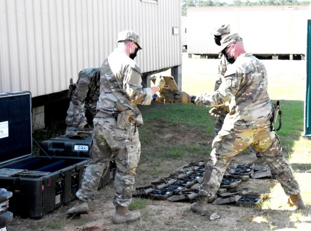 4th SFAB Soldiers lay out MILES gear prior to issuance while adhering to social-distancing and COVID-19 mitigation measures.
