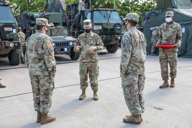 ANSBACH, Germany - Brig. Gen. Gregory Brady, 10th Army Air and Missile Commanding General, recognizes Capt. Andrew Defabio, Charlie Battery Commander, 5th Battalion, 7th Air Defense Artillery Regiment, and C Btry. 1st Sgt. Paige Shelton for their efforts and leadership during the COVID-19 crisis at Smith Barracks, Germany May 20.