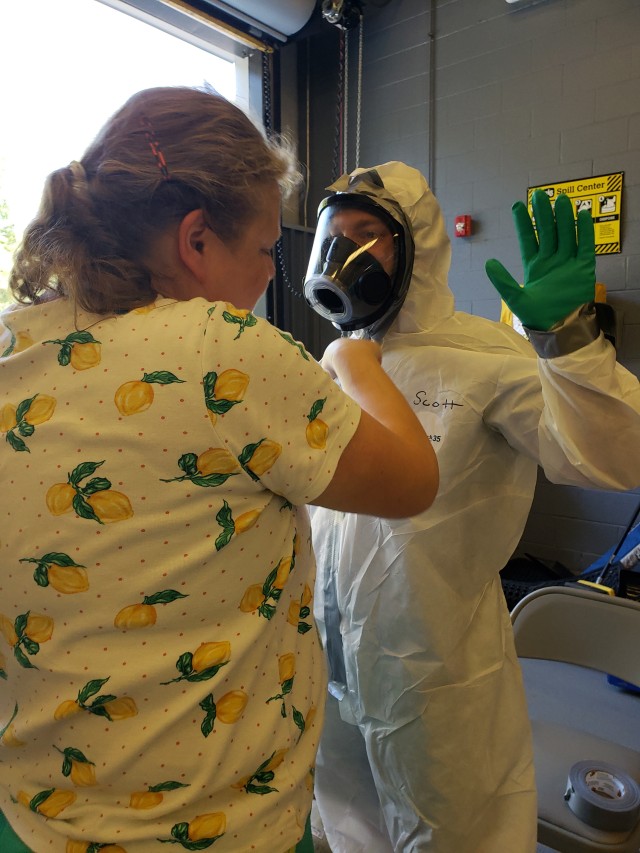 Sybille Vega, industrial stormwater program manager, and an associate take turns helping each other dress out in Hazmat B suits during a training exercise for hazardous materials spill response. Katherine Pezzillo and Dina Huynh also participated in the training, held at the 90 day Hazardous Waste Facility. The Stormwater Team tracks spills throughout the installation and trains DoD military members and tenant contractors at 37 high priority facilities throughout Fort Belvoir to prevent spills or properly handle and clean up spilled materials annually.