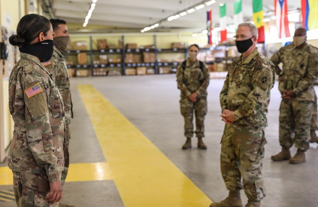 BAUMHOLDER, Germany - Brig. Gen. Gregory Brady, 10th Army Air and Missile Commanding General, talks with Spc. Karla Taylor and Pvt. 1st Class Jose Martinez, both automated logistical specialists assigned to Echo Company, 5th Battalion, 4th Air...