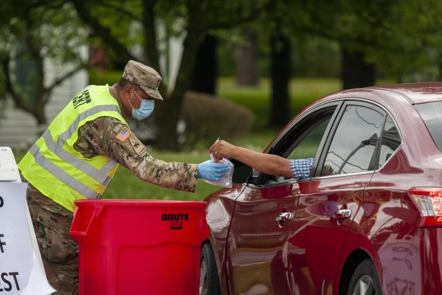 Sgt. 1st Class Jaime Aparicio, a sergeant with the Delaware Army National Guard’s 160th Engineer Company, wears personal protective equipment during a drive-thru coronavirus testing mission at W.T. Chipman Middle School in Harrington, Del., May...