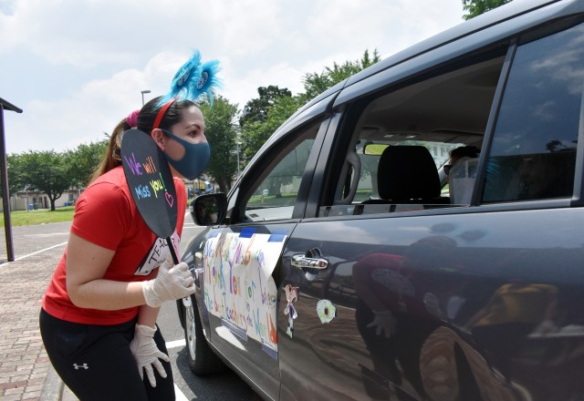 Yeritza Padin, kindergarten teacher at John O. Arnn Elementary School, greets a parent and student during an item exchange on the school’s last day at Sagamihara Family Housing Area, Japan, June 8.
