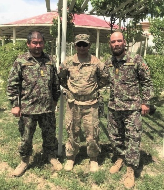 Staff Sgt. Diego Gantivar, center, a senior mechanic advisor with 3rd Squadron, 1st Security Force Assistance Brigade, poses for a photo with his Afghan partners during the brigade&#39;s deployment to Afghanistan in 2018. Gantivar is now assigned to a 45-member task force in Colombia, as part of U.S. Southern Command’s enhanced counternarcotics mission. 