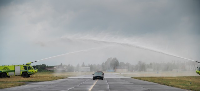 WIESBADEN, Germany - Cars drive under a water salute on the airfield on Clay Kaserne during the Wiesbaden High School graduation ceremony June 5, 2020 at U.S. Army Garrison Wiesbaden.