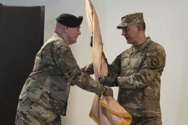 U.S. Army Maj. Gen. Michael D. Turello, outgoing commander of Combined Joint Task Force-Horn of Africa (CJTF-HOA), left, passes the command guidon to U.S. Army Gen. Stephen J. Townsend, commander of U.S. Africa Command, right, during a socially distanced change of command ceremony, June 8, 2020, at Camp Lemonnier, Djibouti. Turello relinquished command to U.S. Army Maj. Gen. Lapthe C. Flora. (U.S. Air Force photo by Tech. Sgt. Ashley Nicole Taylor)