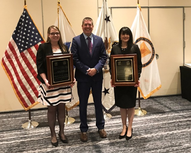 Stephanie James (left) and Serina Allingham (right) are joined by Jake Adrian, director, LOGCAP Contracting, following the Secretary of the Army Awards for Excellence in Contracting (SAAEC) award ceremony in Washington, D.C., in December 2019. (U.S. Army photo)