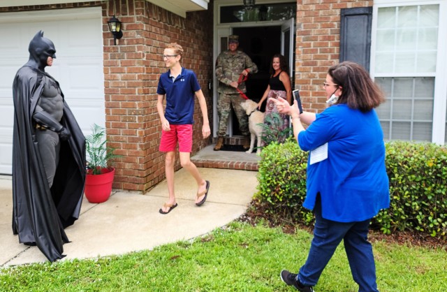 Sgt. Anthony Licata, a trumpet player assigned to the 3rd Infantry Division Band and dressed at Batman, congratulates the Fort Stewart/Hunter Army Airfield 2020 youth volunteer of the year winner, Preston Ver Hoef, June 4, 2020, in Richmond Hill, Georgia. “Batman” presented Ver Hoef the award for over 60 hours of community service through Richmond Hill Middle School by offering support to special needs students. (U.S. Army photo by Sgt. Arjenis Nunez)