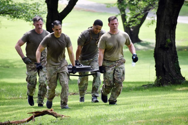 Capt. David Ragsdale, front right; Capt. Matthew Remley, front left; Sgt. 1st Class Stanley Green, back right; and Lt. Col. Christopher Browning, back left, all assigned to I Corps Forward, compete in the litter carry during the U.S. Army Japan...