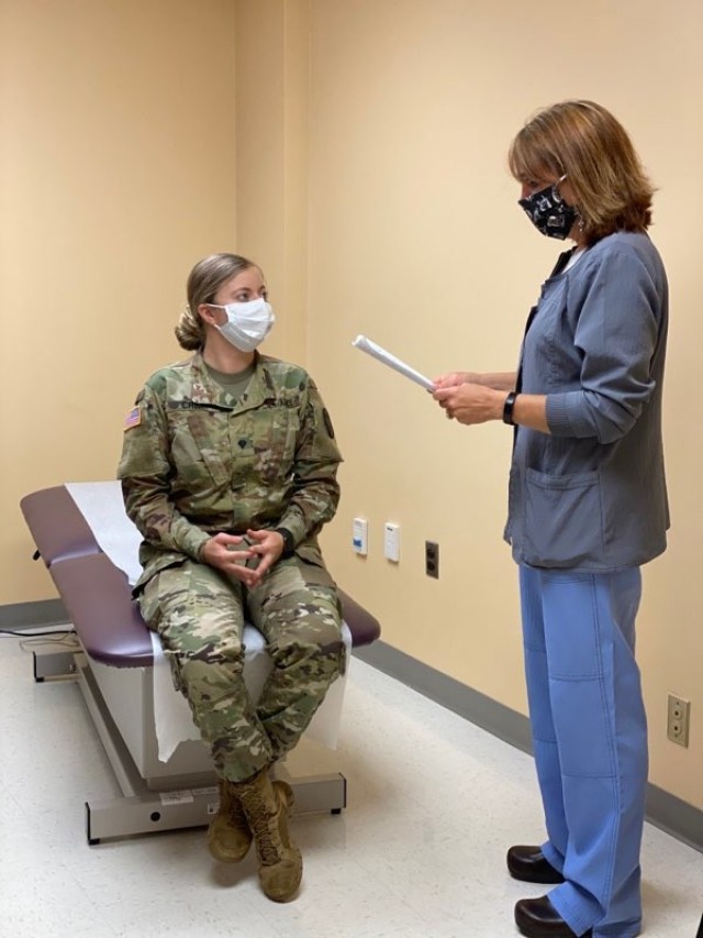 Micki D. Cavender, clinical nurse officer-in-charge for the Orthopedic and Podiatry Clinic, meets with Spc. Samantha Crim, June 8, at the Surgery Super Clinic. Cavender is responsible for ensuring her team at the clinic have the proper personal...