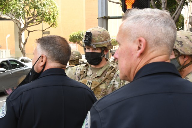 Capt. Travis Leach, Company Commander for Bravo Company, 1st Battalion, 160th Infantry Regiment, links up with Los Angeles Police Department officers at Pershing Square in downtown Los Angeles on May 31, 2020. His Soldiers were tasked to support...