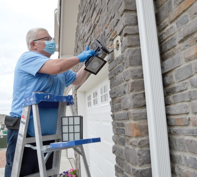 FORT CARSON, Colo. — Mark Chamberlain, residential maintenance technician, Balfour Beatty Communities, repairs a gutter at a home in the Cherokee Village neighborhood on post June 9, 2020. (Photo by Scott Prater)