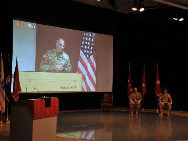 Gen. Gus Perna, commanding general Army Materiel Command, addresses the small crowd during a virtual change of command June 12 at the Detroit Arsenal, Michigan.  Brig. Gen. Darren Werner (seated left) assumed command of Tank-automotive and Armaments Command from Maj. Gen. Dan Mitchell (seated right).