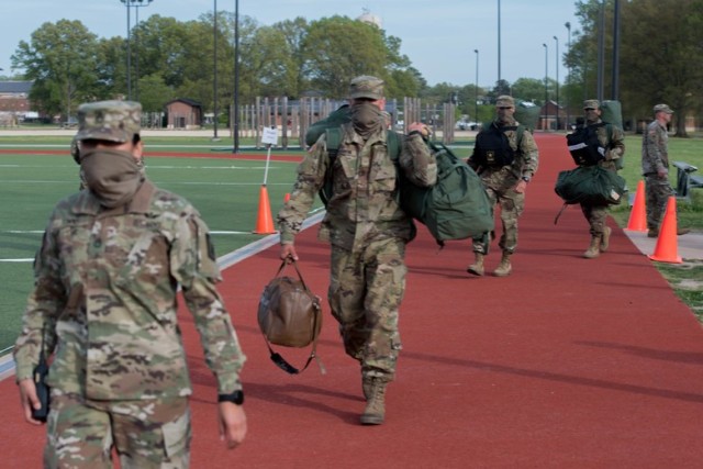A U.S. Army Drill Sergeant escorts new Advanced Individual Training Soldiers to a screening area at Joint Base Langley-Eustis, Virginia, April 8, 2020. The Soldiers arriving were medically screened for symptoms relating to the coronavirus before being assigned a barracks room for their AIT. (U.S. Air Force photo by Senior Airman Derek Seifert)