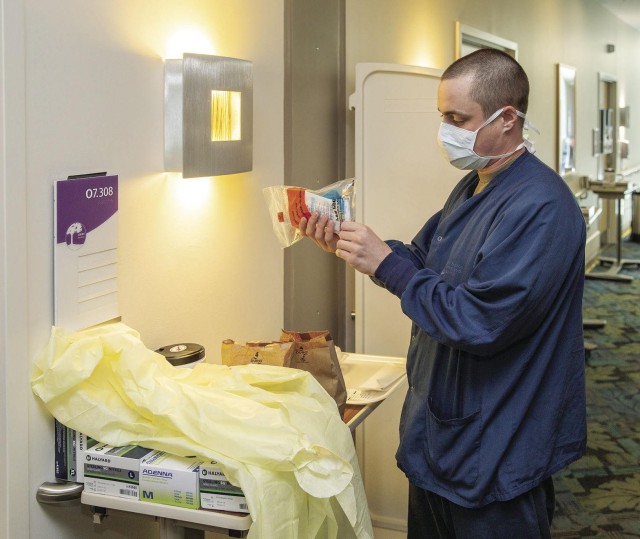 Sgt. Justin Rupp, NCOIC of Inpatient Ward 7 North at Fort Belvoir Community Hospital, checks on supplies. Rupp and his team converted the ward for COVID-19 treatment in 12 hours.