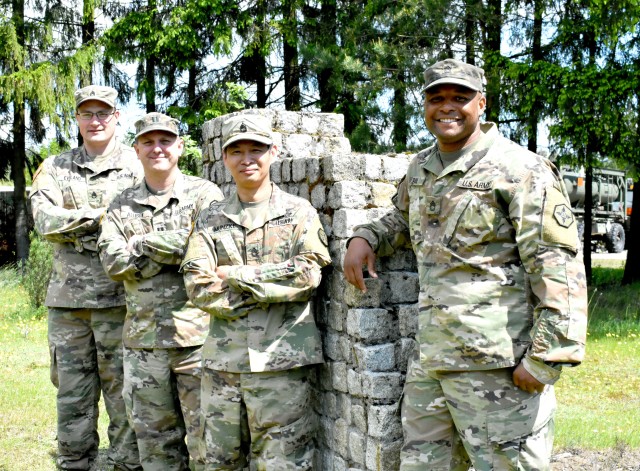 Members of mayor cell stationed in Bemowo Piskie, Poland pose by the historic landmark on their base.  BPTA is a NATO base located in the eastern part of Poland.  652nd Regional Support Group, a U.S. Army Reserve Unit out of Helena, Montana, is the first U.S. Army Reserve unit tasked with providing base operations for 11 base camps in Poland.  Base support includes taking care of lodging, dining, and recreational needs of the tenant Soldiers assigned to that base.