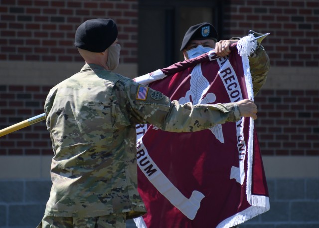 FORT DRUM, N.Y. – Lt. Col. Robert P. Venton (right) and Command Sgt. Maj. Gordon Lawitzke (left), the commander and senior enlisted leader respectively of the Fort Drum Soldier Recovery Unit, uncase the colors of the newly formed Fort Drum Soldier Recovery Unit (SRU) during a ceremony on Fort Drum, N.Y. June 16, 2020.  During the ceremony, the 3rd Battalion, 85th Mountain Infantry Regiment Warrior Transition Unit (WTU) was re-designated the Fort Drum SRU as part of the Army’s restructuring of the Warrior Care and Transition Program to the Army Recovery Care Program. The new model of wounded warrior care will simplify entry criteria, streamline processes and focus resources to foster an environment that will serve individual wounded, ill and injured Soldiers. (U.S. Army photo by Warren W. Wright Jr., Fort Drum Medical Activity Public Affairs)