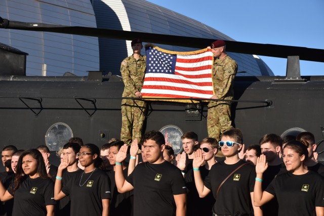 Future Soldiers from the Phoenix Recruiting Battalion recite the oath of enlistment, during a mass enlistment ceremony, Nov. 9, 2017, University of Phoenix Stadium, Glendale, Ariz. The mass took place shortly before a National Football League game between the Arizona Cardinals and Seattle Seahawks. (Photo by Alun Thomas, USAREC Public Affairs)