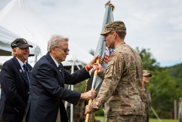 Frank Monaco, a member of the Class of 1970, presents a member of the Class of 2020 with the Class of 2020 Flag at a ceremony after Cadet Field Training in 2017. (Photo Courtesy of Frank Monaco)