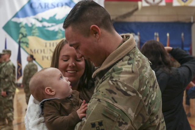 Spc. Jacob Rhodes, assigned to 2nd General Support Aviation Battalion, 4th Combat Aviation Brigade, 4th Infantry Division, returning from an overseas deployment, is reunited with his son Henry and wife Cheyenne following a homecoming ceremony, Feb. 18, 2018, held at the William “Bill” Reed Special Events Center, Fort Carson, Colo. The 4CAB, 4th Inf. Div. was part of a nine-month rotation to Europe in support to Atlantic Resolve, with the mission to train with allies and partners, and demonstrate U.S. commitment to our collective security. 