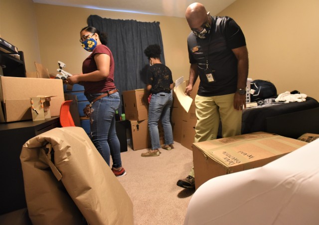 Jay Glover (right), a quality control inspector from the Fort Knox Transportation office, inspects some boxes being packed during a move-out recently. Glover said they are getting prepared for the adjusted peak PCS season, set to begin by July 1 and go into November this year.
