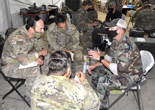 Team leaders with B Co, 1st Bn, 4th SFAB, conduct a key leader engagement exercise with a role player representing a brigade commander in the Afghan army June 17.