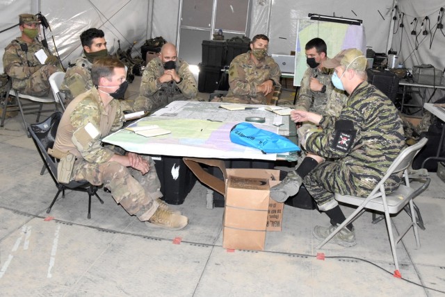 Soldiers with Bravo Company, 1st Battalion, 4th Security Force Assistance Brigade, conduct a key leader engagement June 17 with a role player representing an Afghan army  corps commander.