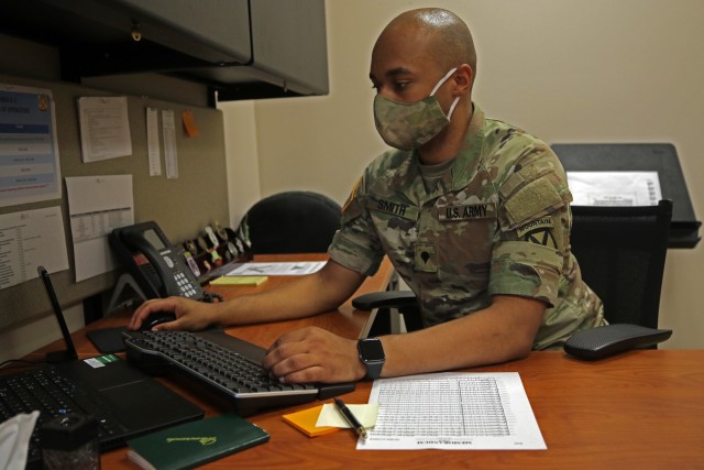 Spc. Nicholas Smith, a Soldier with the 10th Mountain Division (LI) band, works on his music at his desk within the band headquarters, June 11, 2020, at Fort Drum, N.Y. Smith has written seven marches dedicated to the 10th Mountain Division within his two years at the unit and plans to continue writing music throughout his army career.  (U.S. Army photo by Pfc. Anastasia Rakowsky)