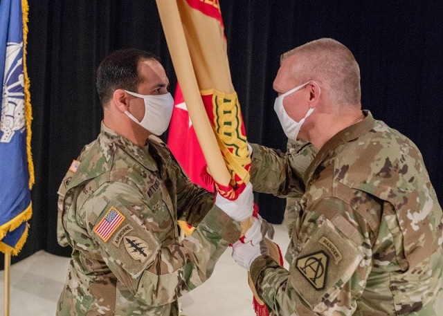 Brig. Gen. Vincent F. Malone II, Picatinny Arsenal commanding general (right), passes the garrison guidon to the incoming garrison commander, Lt. Col. Adam Woytowich.