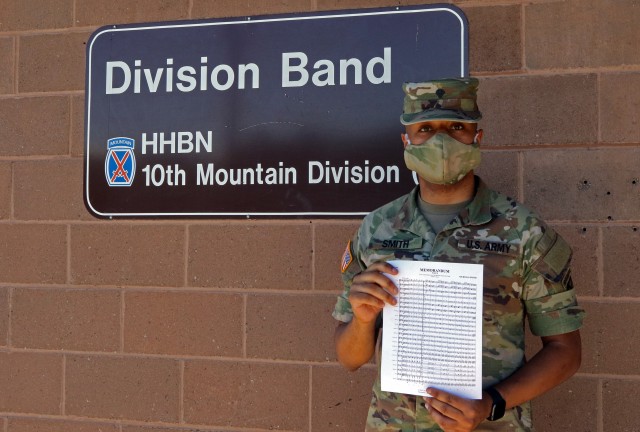 Spc. Nicholas Smith, a Soldier with the 10th Mountain Division (LI) band, poses with his musical composition, “Memorandum March,” outside of the division band headquarters June 11, 2020, at Fort Drum, N.Y. The march was performed by the West Point band during a graduation ceremony for the graduating class of cadets on June 13, 2020.  (U.S. Army photo by Pfc. Anastasia Rakowsky)