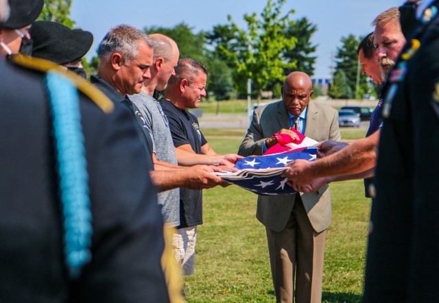 Soldiers both past and present from 1st Battalion, 327th Infantry Regiment “Bulldogs”, 1st Brigade Combat Team, 101st Airborne Division (Air Assault), honor Master Sgt. Thomas LeVesque June 19 by refolding his flag at the Bastogne Memorial, at Fort Campbell, Ky. LeVesque was a 101st Veteran and fought in the Gulf War while a part of 1st BCT. (U.S. Army photos by Spc. John Simpson, 40th Public Affairs Detachment)
