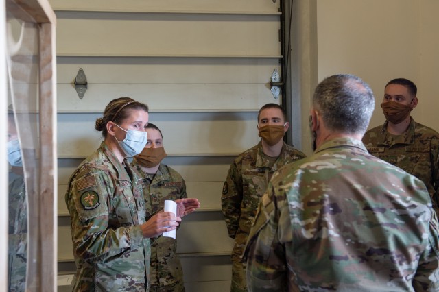 First Lt. Kristina O’Sullivan, 62nd Aircraft Maintenance Squadron flight commander, left, shows Gen. David Goldfein, chief of staff of the Air Force, right, how the 62nd AMXS Consolidated Tool Kit shop is preventing the spread of COVID-19 at...