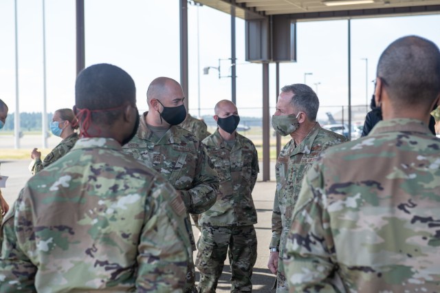 Gen. David Goldfein, chief of staff of the Air Force, right, and Senior Master Sgt. Jonathan Reece, 62nd Aircraft Maintenance Squadron, left, discuss how the wing has continued aircraft maintenance while taking steps to prevent COVID-19 at Joint...