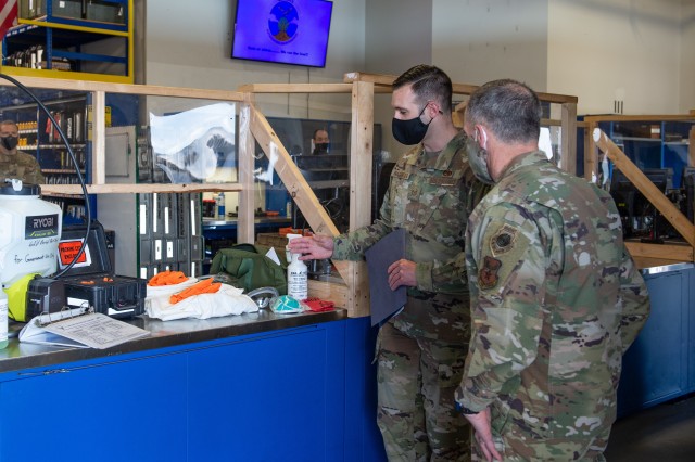 Tech. Sgt. Nathan Nachatilo, 62nd Aircraft Maintenance Squadron, left, explains the process of aircraft decontamination to Gen. David Goldfein, chief of staff of the Air Force, right, at Joint Base Lewis-McChord, Wash., June 18, 2020. During his...